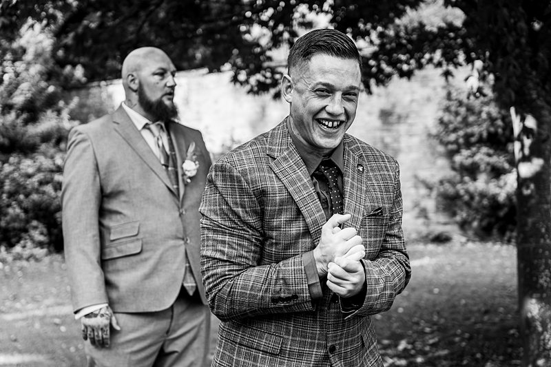 Two men in suits laughing outdoors