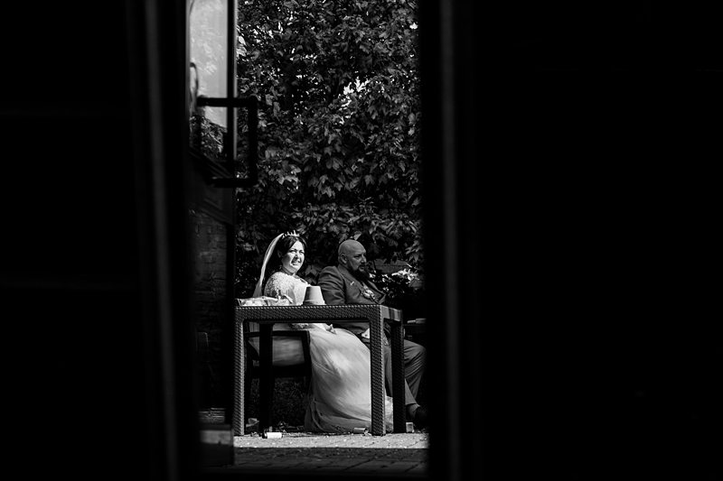 Bride and groom sitting at outdoor table