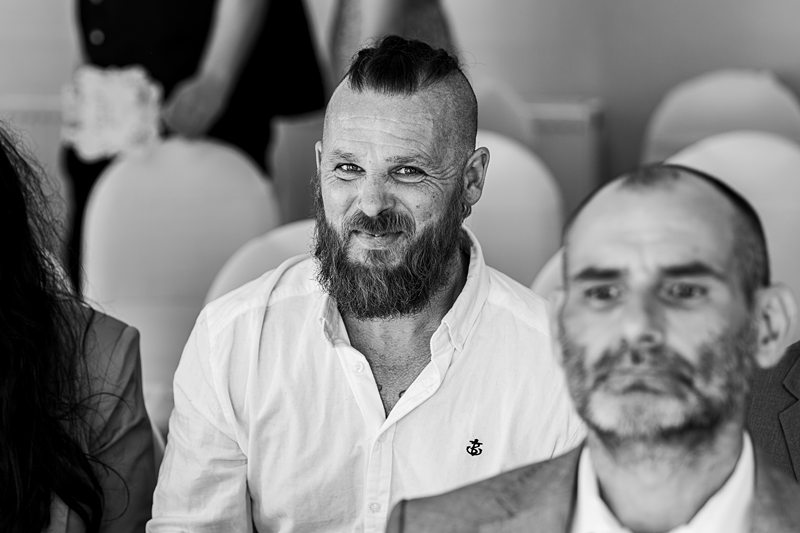 Bearded man at formal event, black and white photo.