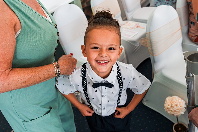 Smiling child in formal attire at an event.