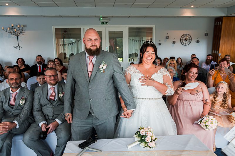 Couple getting married in front of family and friends.