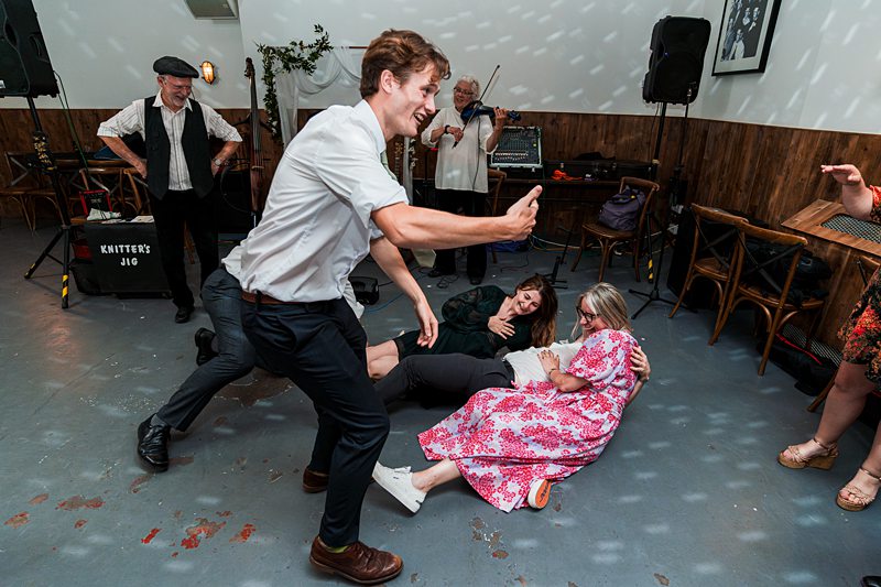 People dancing and laughing at a lively party.