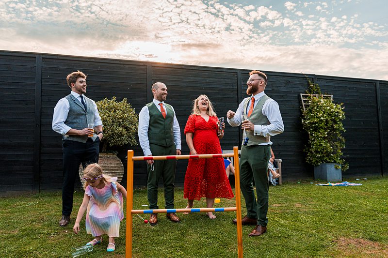 Group enjoying garden party with lawn game