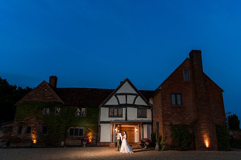 Couple outside illuminated historic building at night