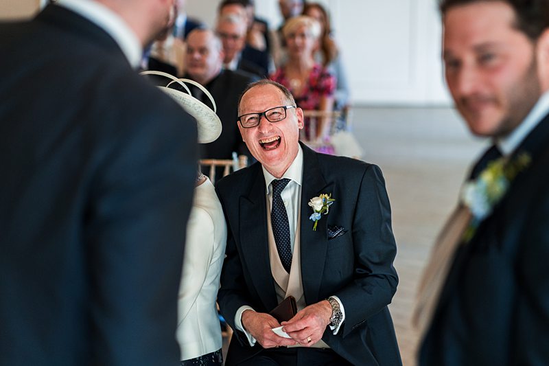 Laughing guest in a wedding ceremony.