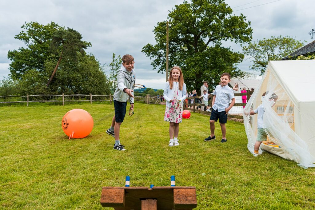 Children playing games outside in the garden.