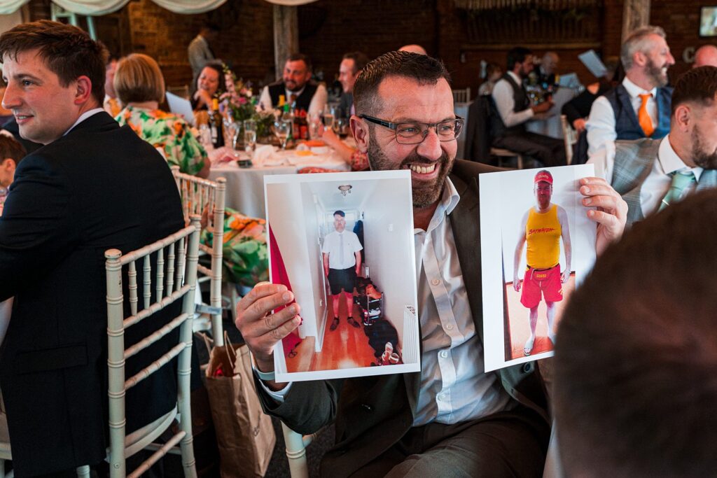Man showing humorous before-and-after photos at event.