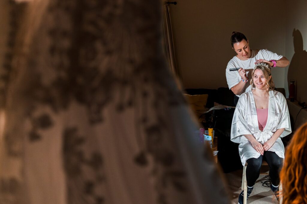 Bride getting ready, hair stylist working.