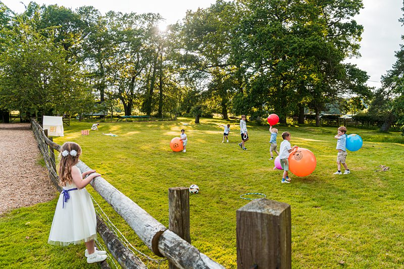 Children playing with colourful balls in a park.