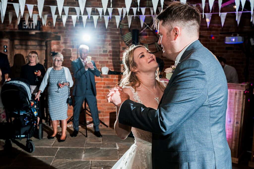 Bride and groom dancing at wedding reception.