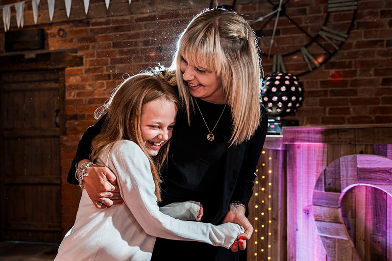 Mother and daughter laughing at a party