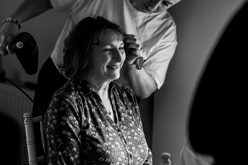 Woman smiling while getting hair styled