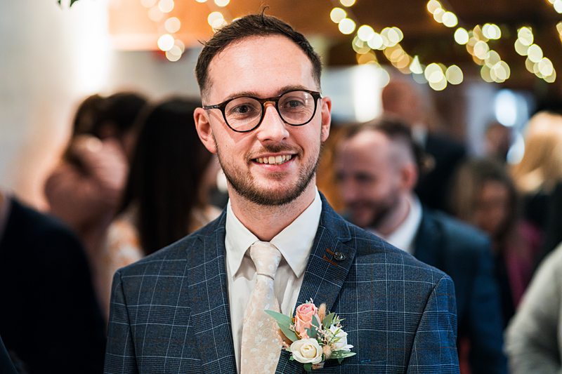 Smiling man in suit with floral boutonniere