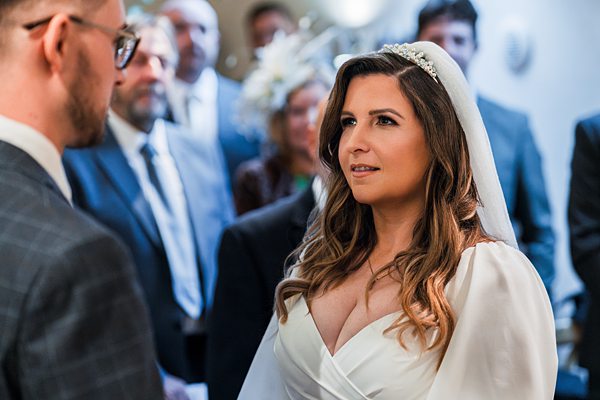 Bride and groom exchanging vows during wedding ceremony.
