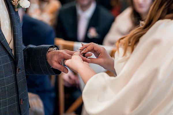 Couple exchanging rings during wedding ceremony