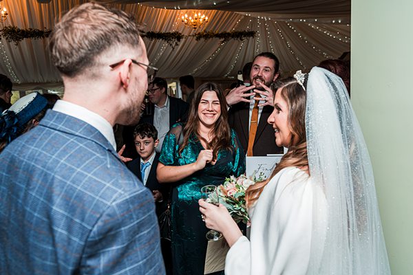 Wedding reception with guests socialising indoors.