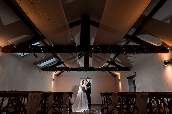 Bride and groom in a decorated wedding venue.