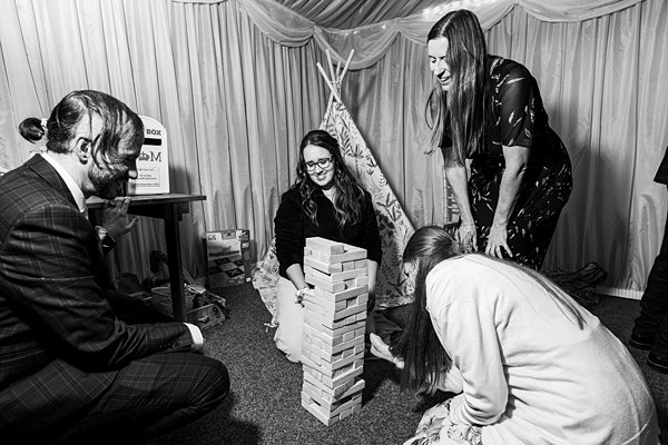Group playing Jenga in a cosy indoor setting.