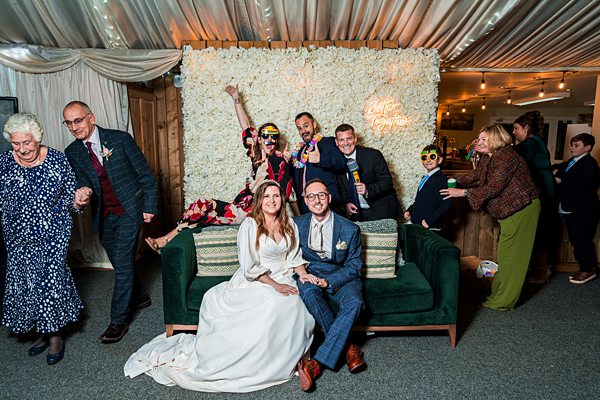 Wedding celebration with bride, groom, and joyful guests.