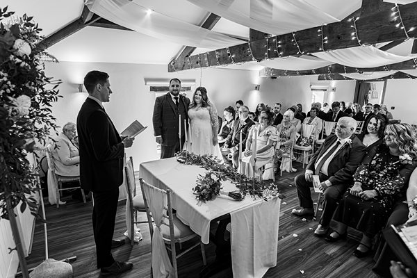 Wedding ceremony with couple and guests in attendance.