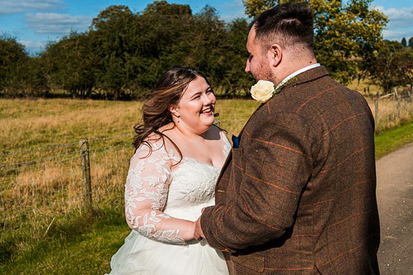 Couple laughing in countryside on sunny day