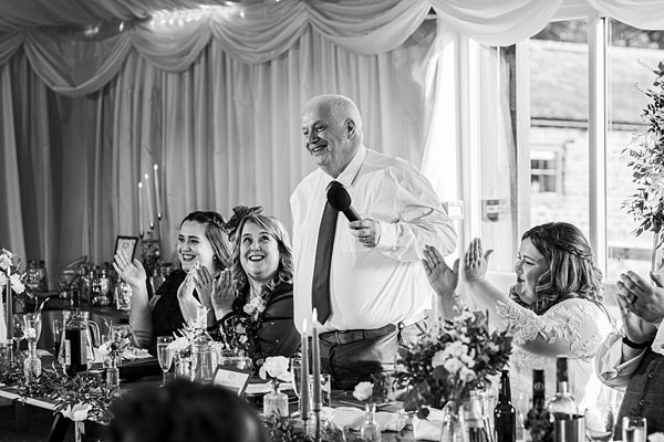 Wedding speech at reception with guests applauding