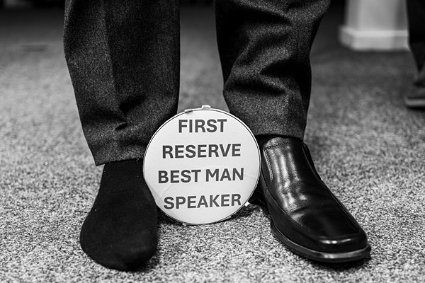 Two shoes, sign: First Reserve Best Man Speaker