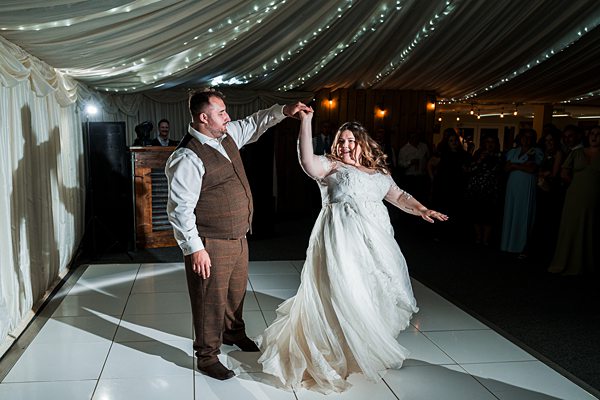 Bride and groom dancing at wedding reception.