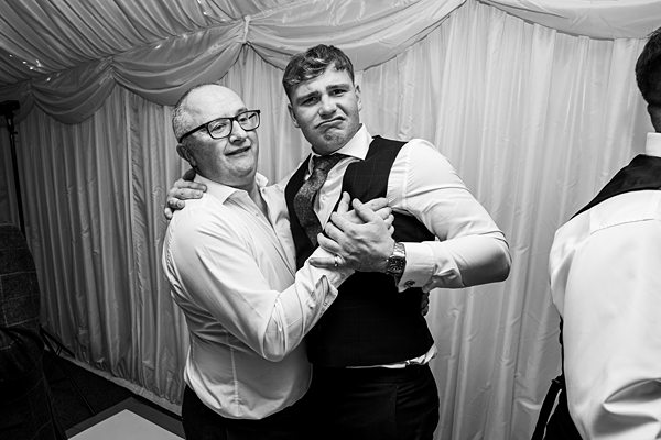 Two men dancing at a formal event.
