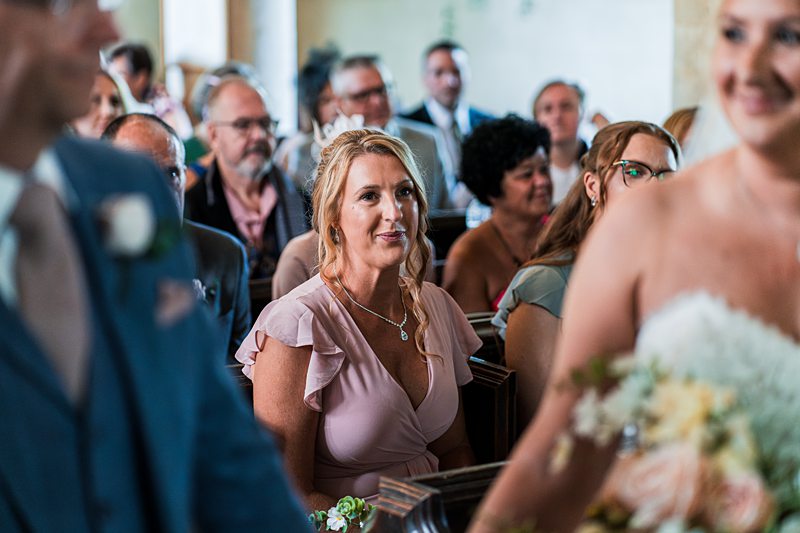 Wedding guests seated in a church.