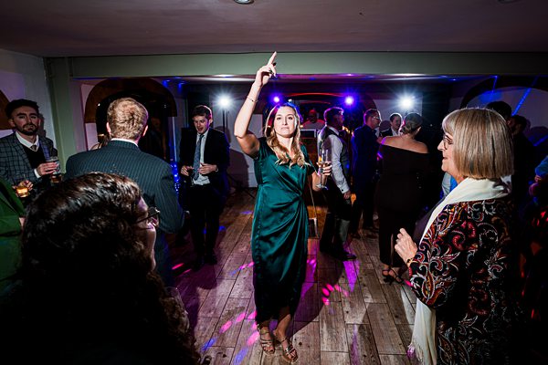 People dancing at a party with colourful lights