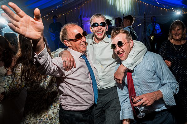 Guests celebrating at wedding reception with smiles