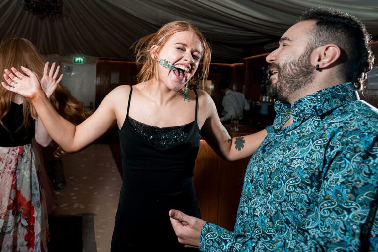 People laughing and dancing at a party.