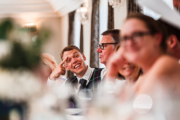 Guests smiling at a wedding reception.