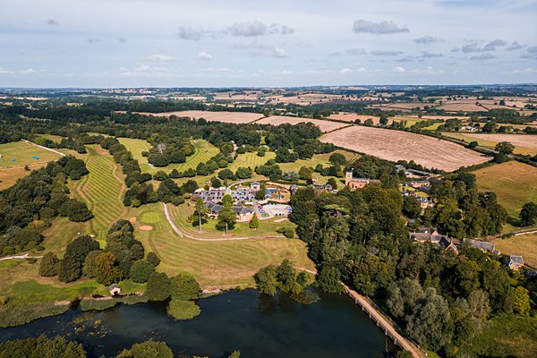 Aerial view of countryside with fields and buildings.