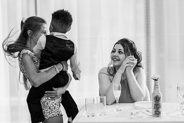 Smiling women enjoying a gathering with a child.