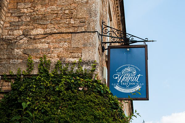 Walnut Tree Inn sign on stone building