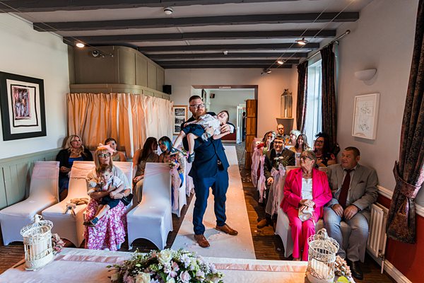 Small wedding ceremony with guests seated indoors.