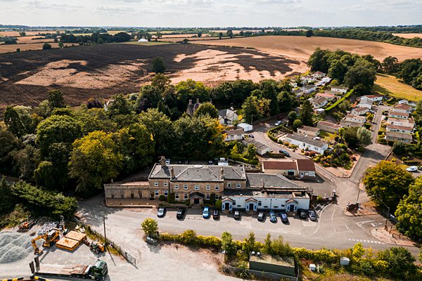 Aerial view of countryside village and fields.