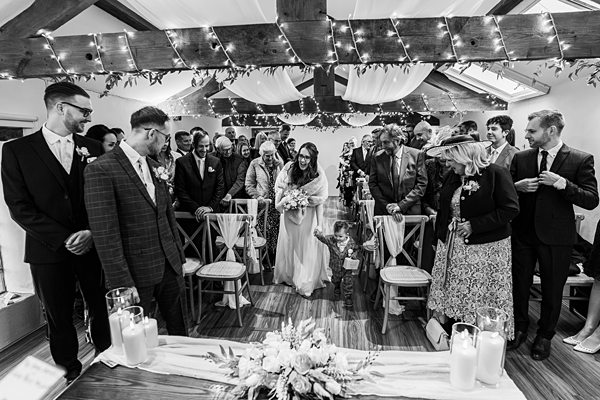 Wedding ceremony with bride walking down the aisle.