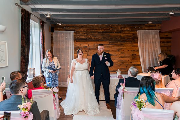 Bride and groom holding hands at wedding ceremony