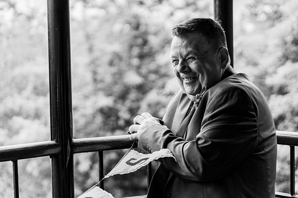 Smiling man in suit on a balcony, black-and-white