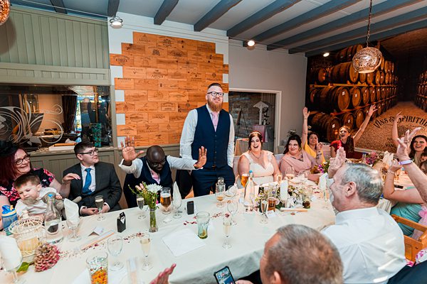 Group cheering at a lively dinner gathering