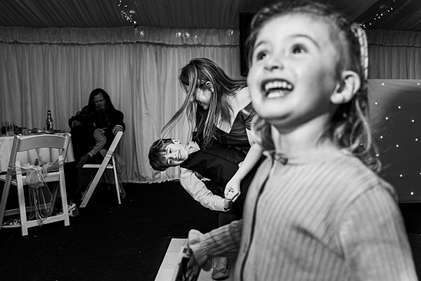 Kids playing and laughing at a wedding reception.