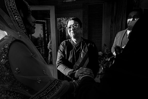 People holding hands in a formal setting, monochrome.
