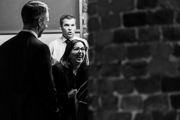 People laughing and socialising at an event.