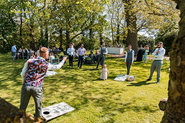 Wedding guests playing garden games outdoors