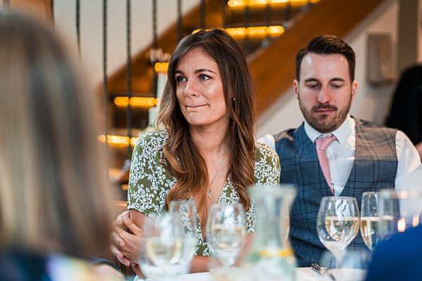 People sitting at a table during an event.