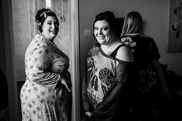 Women smiling during preparation for event.