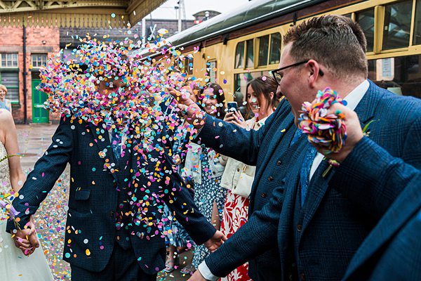 Confetti celebration at a vintage train station wedding.